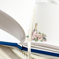 Classic guest book with white pages wirh custom print and satin ribbon marker. Perfect for weddings, retirements, anniversaries, or special events. A timeless keepsake where guests can share heartfelt wishes, notes, and lasting memories.