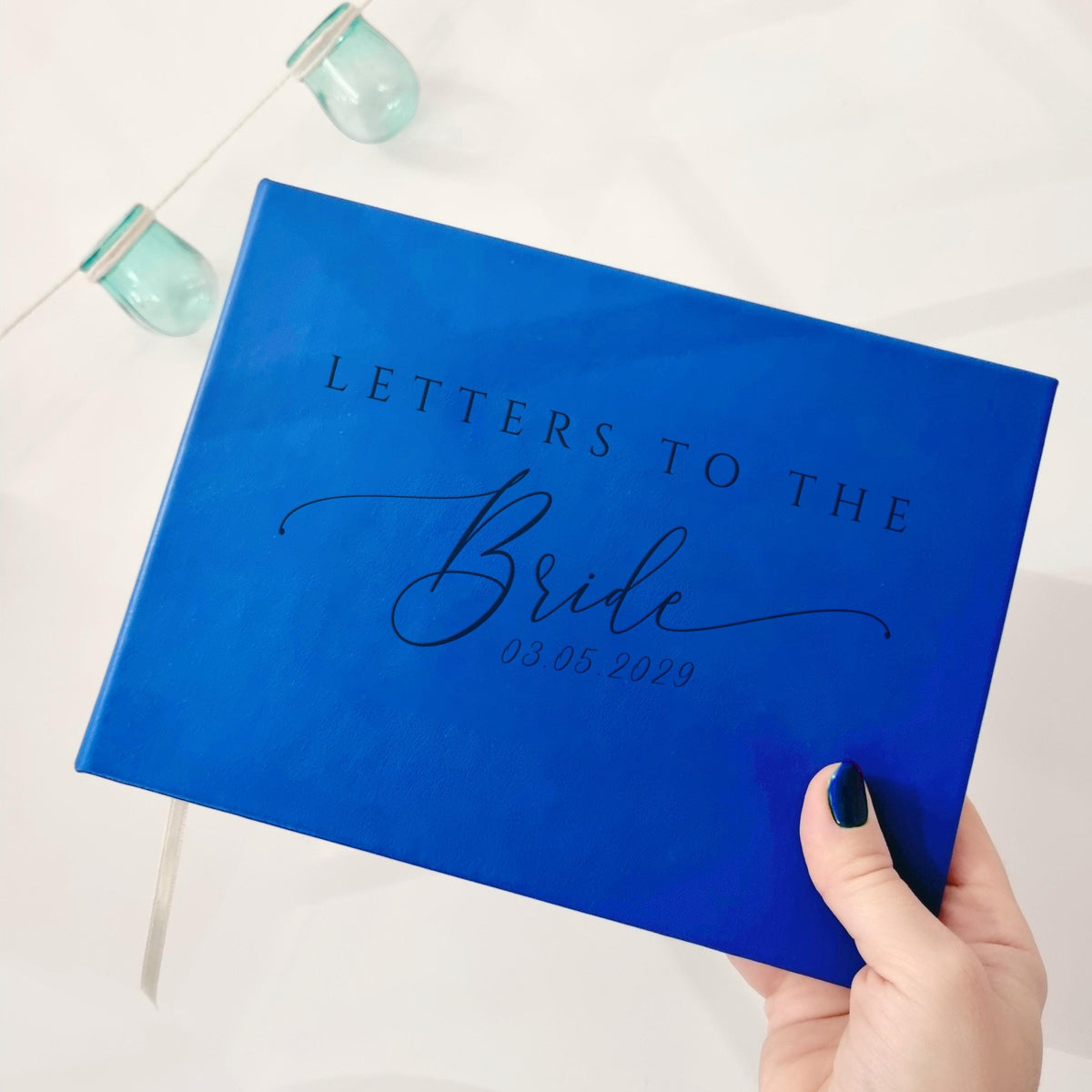 “Letters to the Bride” book with royal blue vegan leather cover and custom engraving. Perfect for bridal showers or weddings, where friends and family can share heartfelt letters, advice, and wishes – a treasured keepsake for the bride.