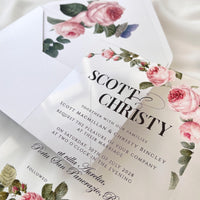 Elegant clear acrylic invitation with rose print, white envelope, and custom wax seal featuring rose motif.