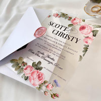 Transparent plexiglass wedding card featuring floral rose motifs, elegant white envelope, and matching liner.