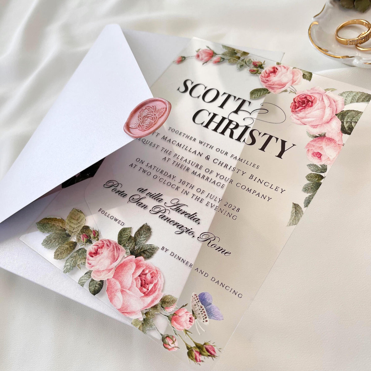 Transparent plexiglass wedding card featuring floral rose motifs, elegant white envelope, and matching liner.