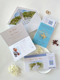 This wedding stationery suite features a blue faux leather passport invitation alongside a boarding pass RSVP card. The ensemble is completed by an elegant envelope lined with a custom watercolor illustration of the wedding venue's location.